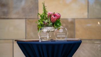 Awards and flowers displayed on a table