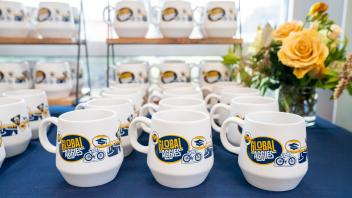 Rows of UC Davis Global Aggies mugs